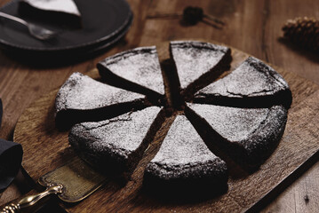 Kladdkaka. Traditional Swedish moist chocolate cake on wooden table. Fika. Hygge. Winter treat