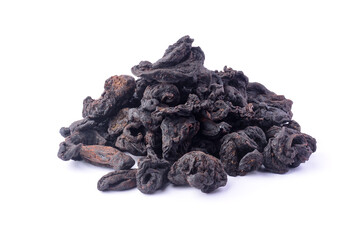 pile of sun dried garcinia fruits, black shriveled flavoring herb native to south asia, also known as brindle berry, goraka or malabar tamarind, isolated on white background