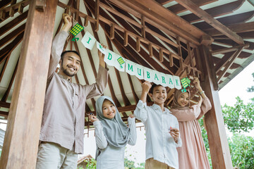 Asian Muslim family decorates gazebo to celebrate Eid Mubarak