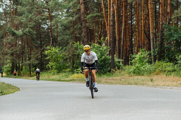 Male cyclist spends time actively cycling in the woods outdoors. Active recreation on a bicycle.