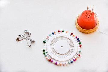 Multicolored needles and hairpins on a white background
