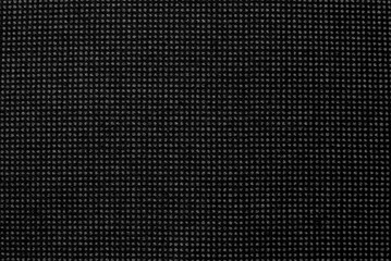 Background made of fabric with small dots and lines. Texture. Material for tailoring. Pattern of dense dark fabric
