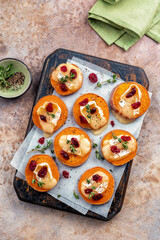 Baked Sweet Potato Rounds topped with brie cheese, cranberry and Walnut. Thanksgiving appetizer bites.