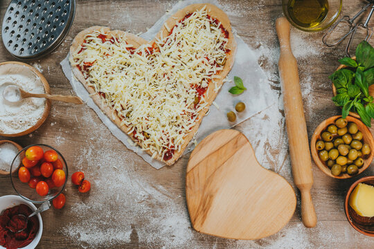 Heart shape homemade pizza on the table