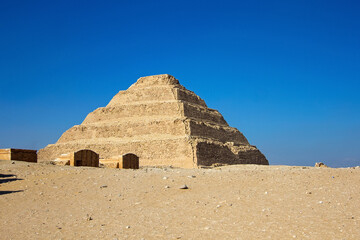 Fototapeta na wymiar Step pyramid of Djoser is archaeological and historical site in Saqqara necropolis, south of Cairo, Egypt, North Africa. This oldest egyptian Pyramid is the prototype of Giza's
