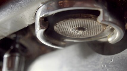 Close up of Pouring water stream from professional coffee machine, Crema Espresso from coffee maker...