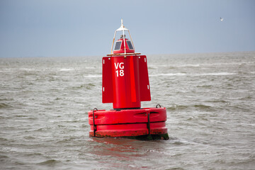 A red channel marker buoy in the water. © Schemken