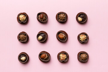 Different kinds of chocolates on colored table close-up. Top View and Flat Lay
