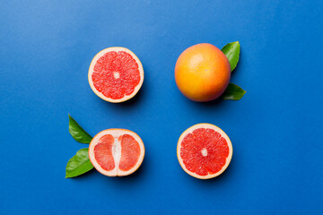 fresh Fruit grapefruit with Juicy grapefruit slices on colored background. Top view. Copy Space. creative summer concept. Half of citrus in minimal flat lay with copy space