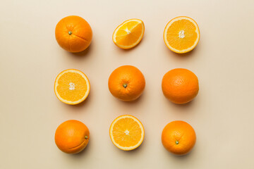 Fruit pattern of fresh orange slices on colored background. Top view. Copy Space. creative summer concept. Half of citrus in minimal flat lay