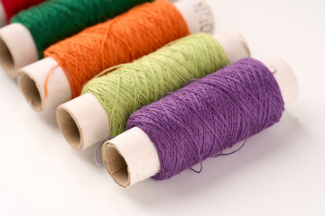 Sewing threads. Spool of thread with on white isolated background. Multicolor sewing threads background.