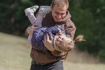 Father lifting up daughter