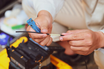 Fiber optic splice procedure Technician Fiberoptic Fusion Splicing. Worker connecting for Cable Internet signal and Wire connection with Fiber Optic Fusion Splicing machine.