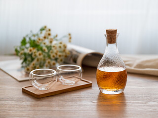 There are wine bottles and glasses on the table