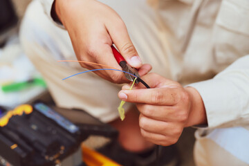 Fiber optic splice procedure Technician Fiberoptic Fusion Splicing. Worker connecting for Cable Internet signal and Wire connection with Fiber Optic Fusion Splicing machine.