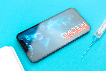 Omicron B.1.1.529 vaccination concept. Medical table with syringe and vaccine vials, world epidemic...