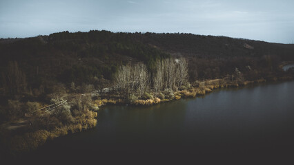 Aerial view of the forest, mountains and the Yagorlyk river. Dark and gloomy landscape, artistic photo processing.