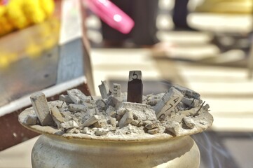 Gray ashes in an incense burner  Burning incense sticks  It is popular with Thai people on the lottery day.