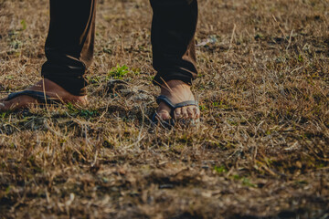 walking on the grass, wearing slippers