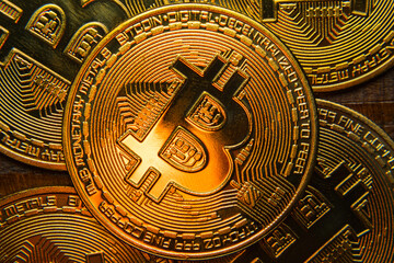 Bitcoin coins on a dark wooden background. BTC cryptocurrency top view. Blockchain technology. Close-up.