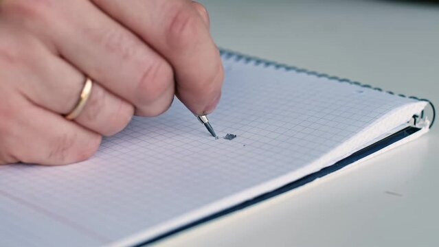 Distracted Caucasian Male Procrastinating Drawing Abstract Rectangles in Square Ruled Notebook during Boring Meeting