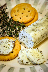 Closeup of homemade herb butter, made with English thyme (Thymus vulgaris), on a decorative plate