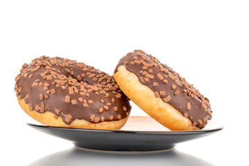 Two sweet chocolate donuts on a ceramic saucer , macro, isolated on white.