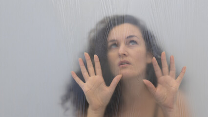 Blurred, out of focus portrait of beautiful sexy seductive lockdown sensual expectant woman behind...