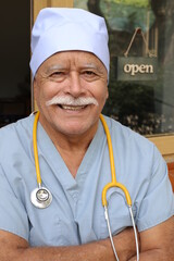 Senior healthcare worker wearing blue scrubs