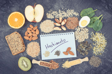 Notepad with inscription hashimoto and best ingredients or products for healthy thyroid. Food as source vitamins