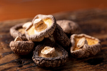 Dried shiitake mushrooms on a wooden background close up