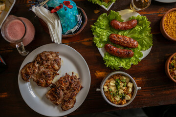 Delicious Food Contemporary Classic Dish Plate Menu Lunch Dinner Chicken BBQ Pork Sausage Bacon Regional Native Dessert on a WoodenTable