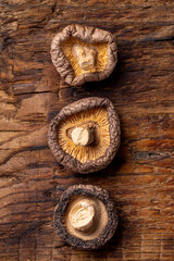 Fototapeta na wymiar Dried shiitake mushrooms on a wooden background top view vertical photo