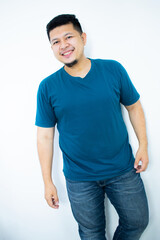Asian young man wearing a dark green shirt smiling and looking at the camera in the white background