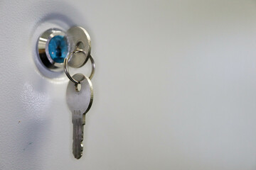 small metal key in the keyhole close up