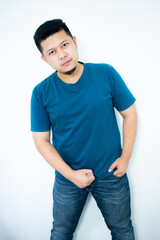 Asian young man wearing a dark green shirt smiling and looking at the camera in the white background