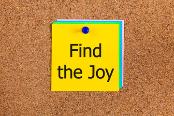 Notes with words Find the Joy on corkboard