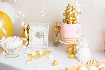 Holiday birthday table with cake and ballons. Pink and golden decoration