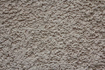 Plastered grey porous wall background texture