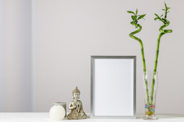 Floral card or poster mockup or silver photo frame with bamboo plant in glass vase,  decorative...