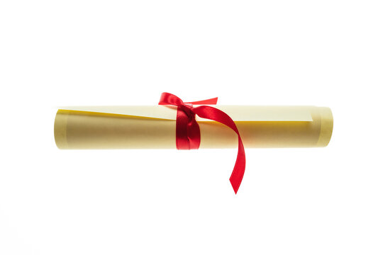 Diploma scroll with red ribbon isolated on white. College degree certificate, University studies