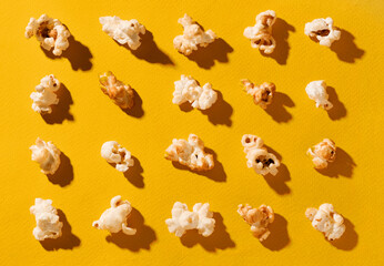 Closeup popcorn abstract background on yellow. Copy space