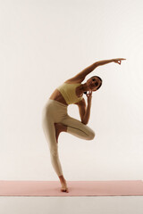 young woman doing yoga poses on white background