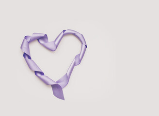 Heart shape made of ribbon on white background. Valentines and 8 March Mother Women's Day concept