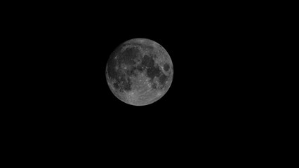 Full Earth's Moon glow on black background. Image in high resolution. Bright lunar satellite