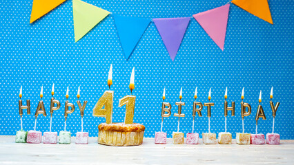 Congratulations on your birthday from the letters of the candles number 41 on a blue background...