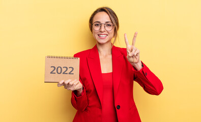 pretty young woman holding a 2022 calendar
