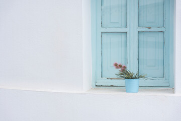 Blue window with flowers. Mediterranean architecture 