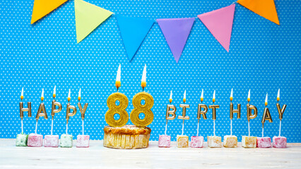 Happy birthday from candle letter number 88 on blue background with white polka dot copy space....