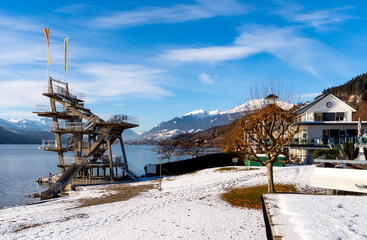 Fototapeta na wymiar Lake promenade with jump tower at Millstadt lake (Millstätter See), Austria
